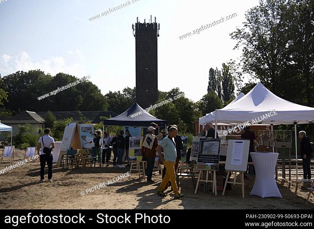 02 September 2023, Brandenburg, Potsdam: Tents stand in front of the historic buildings at the open day in the new Krampnitz residential quarter