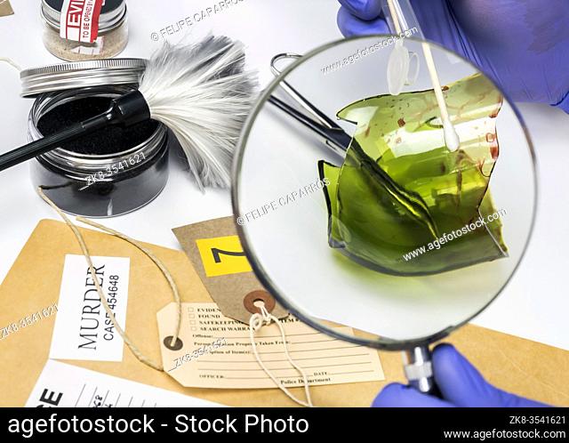 Police expert gets blood sample from a broken glass bottle in Criminalistic Lab, conceptual image