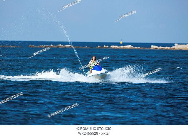 Woman in jet boat racing at high speed