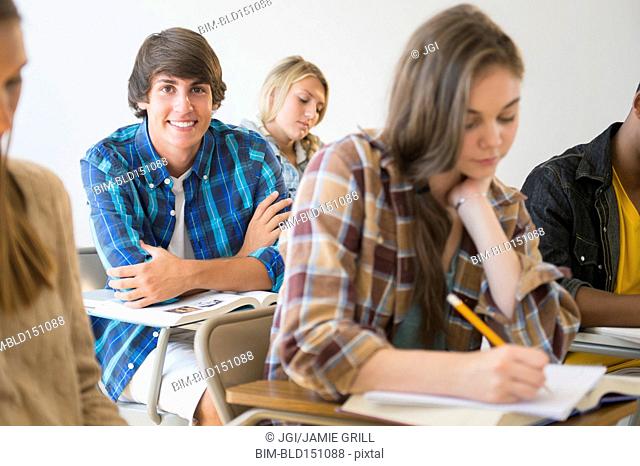 Teenage student smiling in classroom