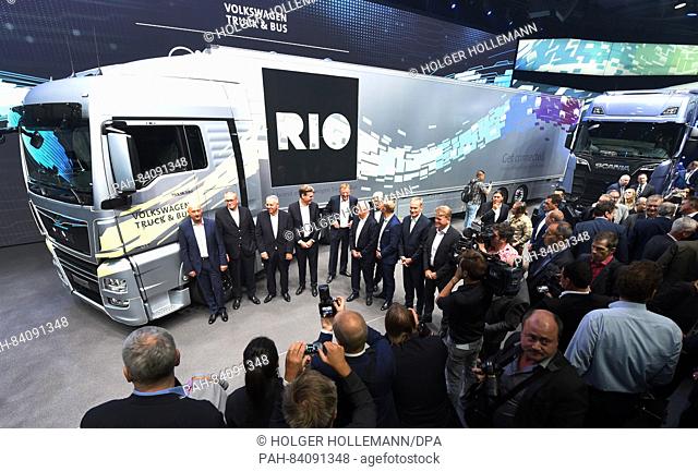 VW management board member with responsibility for commercial vehicles, Andreas Renschler (C),  and members of the Truck board stand in front of the new digital...