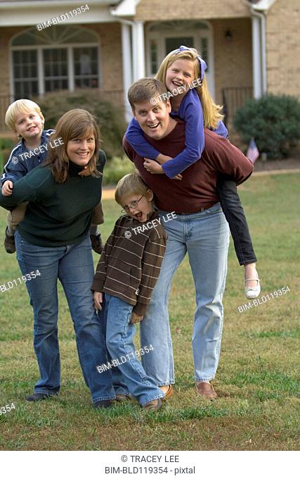 Family playing together on front lawn