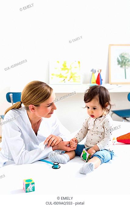 Paediatrician doing assessment of baby boy