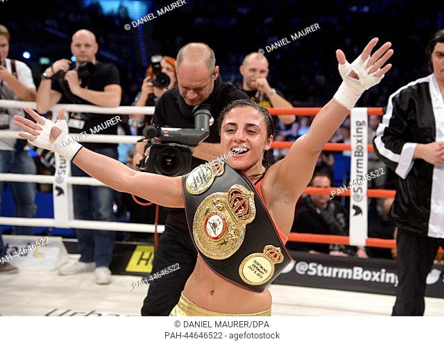 Germany's WBA world champion in lightweight boxing, Susi Kentikian, cheers after winning the bout against Italy's Simona Galassi at the Porsche Arena in...