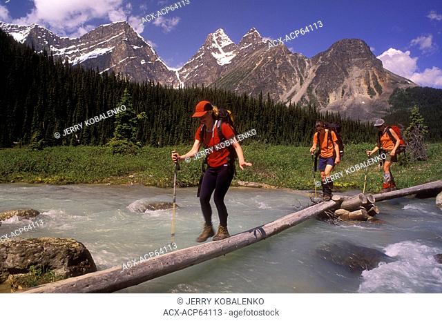 Tonquin Valley; 3 women crossing Eremite Creek, Jasper National Park, Alberta, Canada