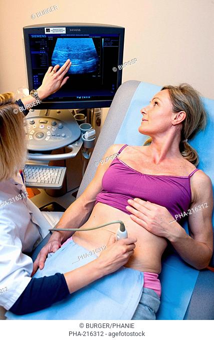 Woman undergoing pelvic ultrasound scan. Limoges hospital, France