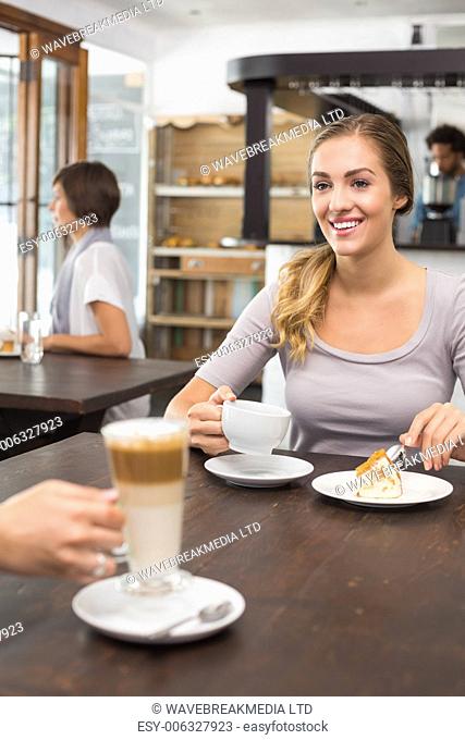 Pretty blonde meeting with a friend at the coffee shop