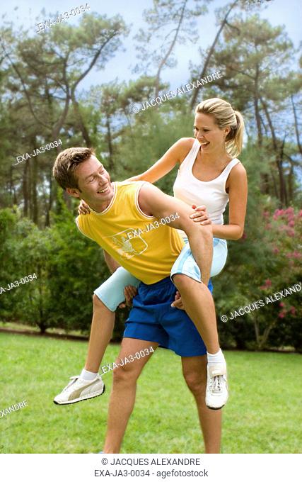 Man giving woman piggyback ride