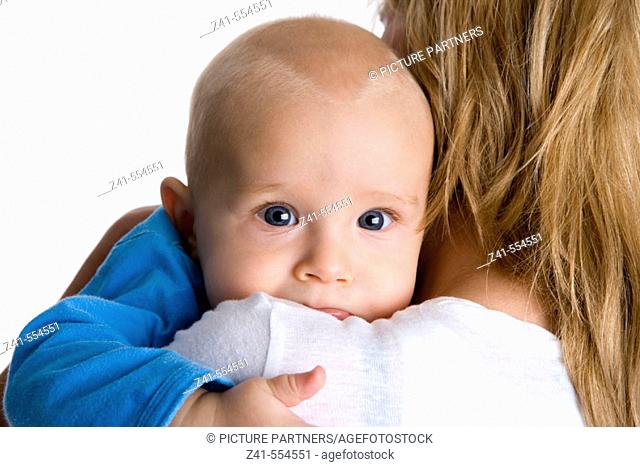 Baby looking over mothers shoulder