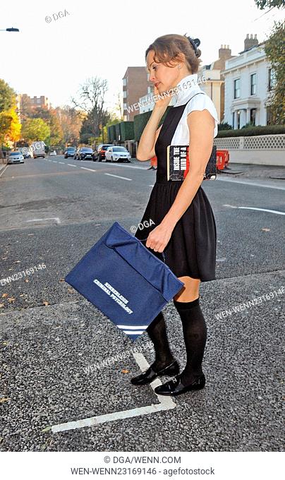 TV presenter and criminal psychologist, Kim Frickleton talks on her mobile phone after a class. The Cambridge University graduate dressed in a school girl...