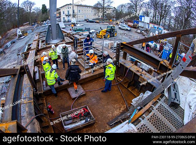 18 January 2023, Mecklenburg-Western Pomerania, Sassnitz: Fitters prepare to lower the new skywalk above the chalk cliff ""Königsstuhl"" on the Baltic Sea...