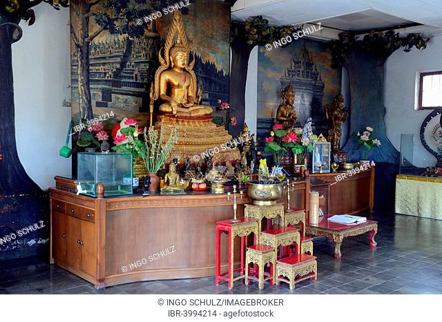 Buddha statue on an altar in a prayer hall of the Buddhist Brahma Vihara Monastery, Banjar, North Bali, Bali, Indonesia