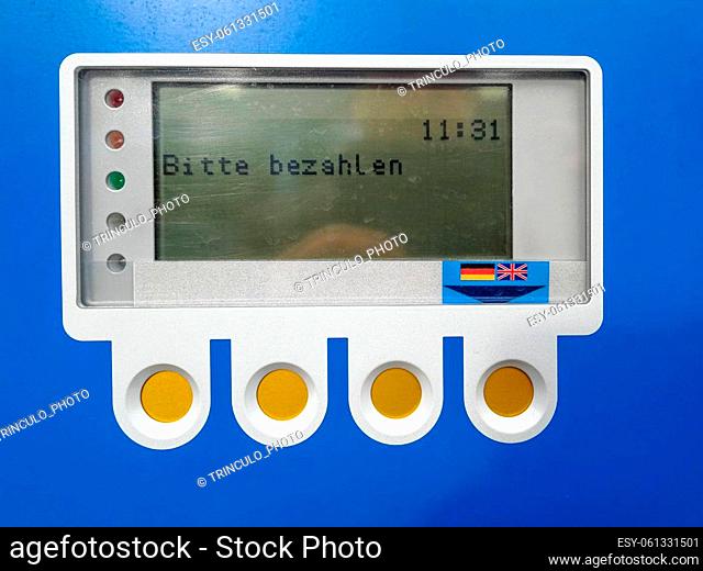 LCD control panel and function keys of a blue parking meter with the prompt Payment required in german language