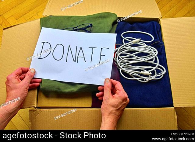 Donation concept. Donation box with donation clothes and accesories. Charity. Helping poor and needy people