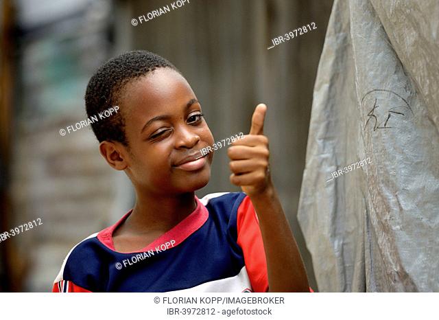 Young winking and giving his thumbs up, Camp Icare for earthquake refugees, Fort National, Port-au-Prince, Haiti