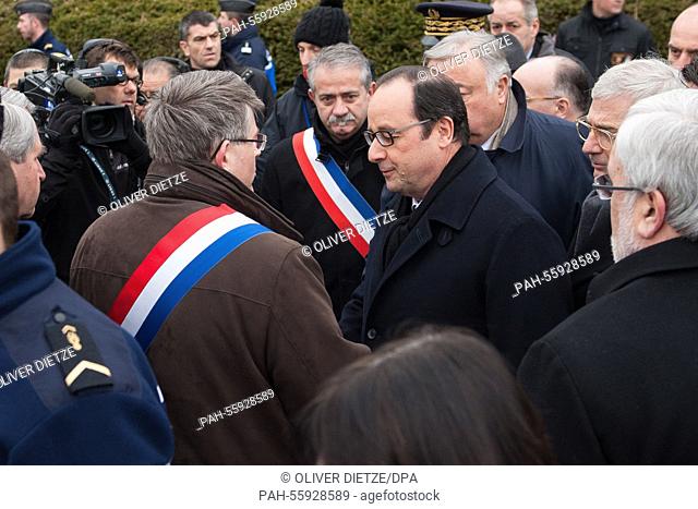 French President François Hollande welcomes city delegates during a commemoration at a Jewish cemetery in Sarre-Union, France, 17 February 2015
