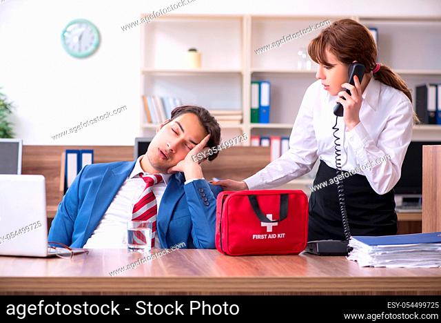 Employee receiving first aid in office