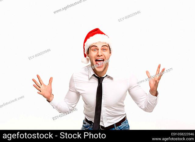 Christmas Concept - Handsome Business man wear santa hat posing with surprising facial expression on white isolated background