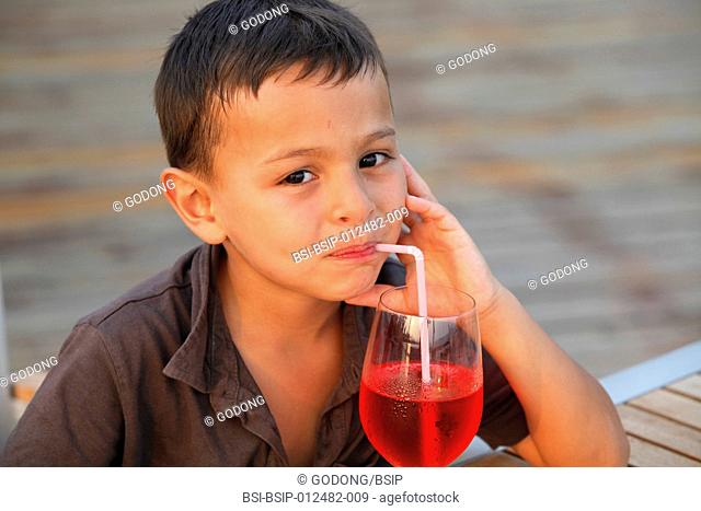 Boy drinking with a straw