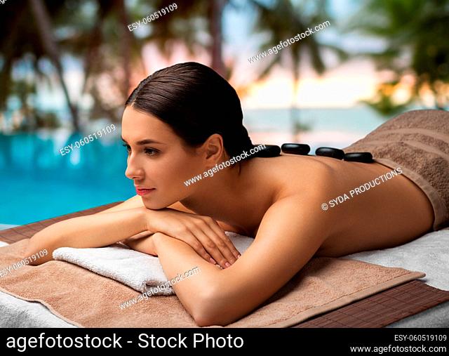 woman having hot stone massage at spa