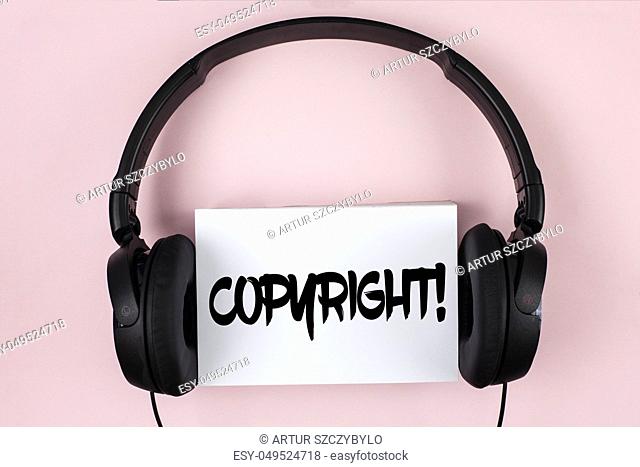 Handwriting text Copyright Motivational Call. Concept meaning Saying no to intellectual property piracy written White Sticky Note paper plain Pink background...