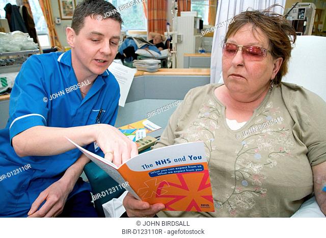 Nurse going through an NHS leaflet with a patient on the Nottingham City Hospital Renal Unit