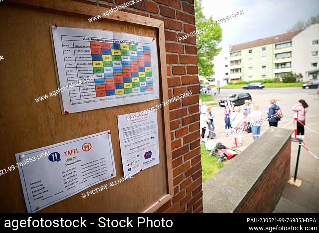 PRODUCTION - 15 May 2023, Schleswig-Holstein, Lübeck: A calendar with color-coded sequences hangs at the entrance to the Junge Tafel distribution point on...