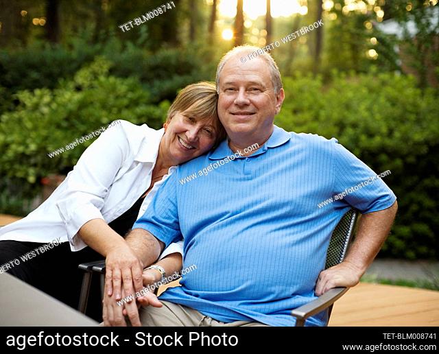 Caucasian couple sitting together and holding hands