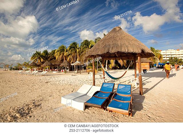 Thatched umbrellas, sunbeds and tourists at the sandy beach, Isla Mujeres, Cancun, Quintana Roo, Yucatan Province, Mexico, North America