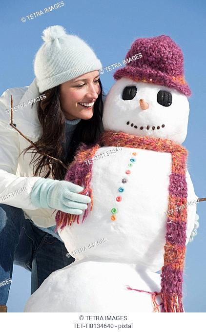 Woman and snowman, smiling