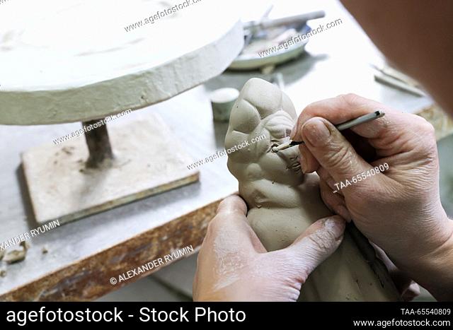 RUSSIA, SKOPIN - DECEMBER 7, 2023: An artist makes a Christmas decoration at the Skopin Art Pottery factory in the town of Skopin in Russia’s Ryazan Region