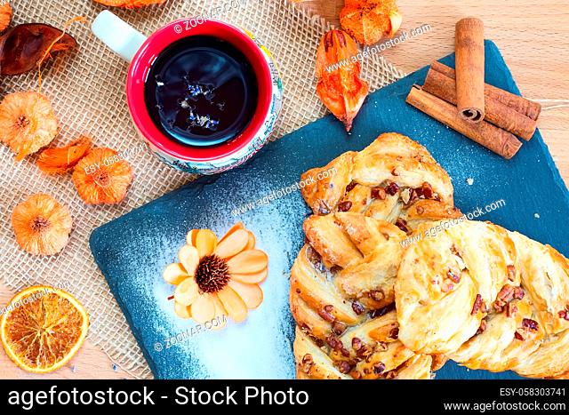 marple and pecan plait pastry sweet food breakfast with tea cup and flower
