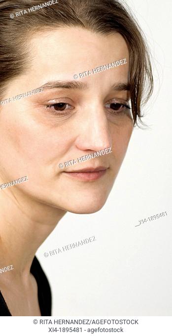 mature woman looking down with sorrow expression