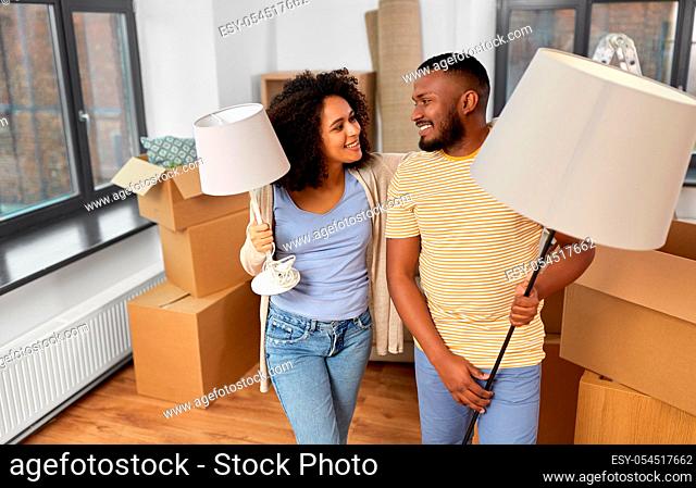 happy couple packing boxes and moving to new home