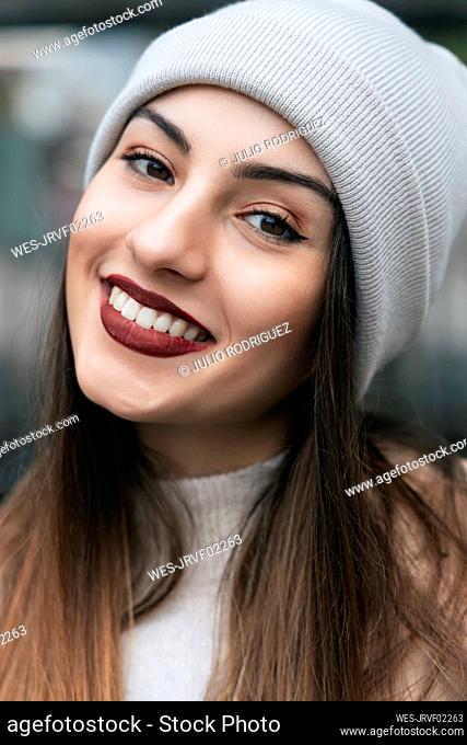 Beautiful woman smiling wearing knit hat