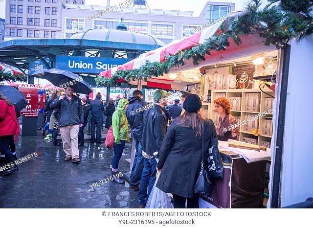 Shoppers browse the Union Square Holiday Market in New York on a rainy Saturday.. 150 vendors, including a ''Made in Brooklyn'' section