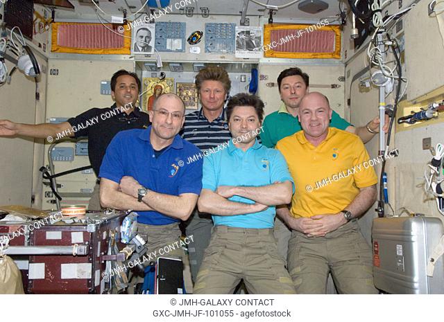 Expedition 31 crew members pose for an in-flight crew photo in the Zvezda Service Module of the International Space Station