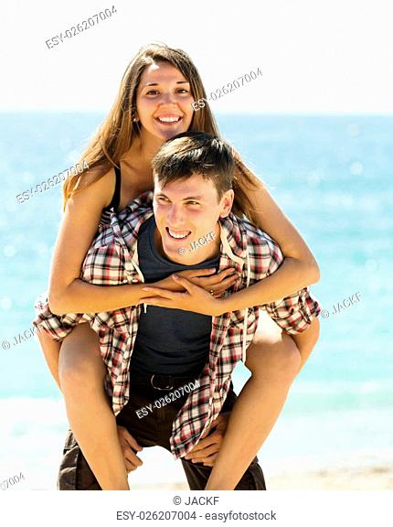 Happy loving couple at seaside in summer day