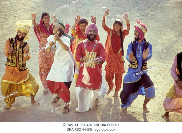 Folk dance ; men and women performing bhangra ; punjab ; india