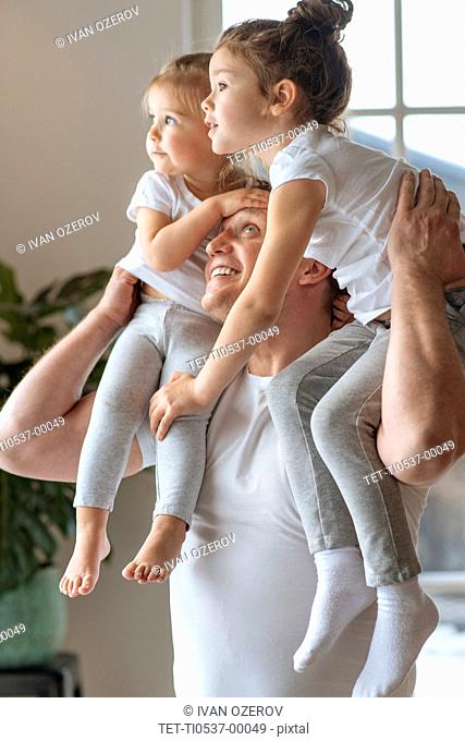 Father with his daughters on his shoulders