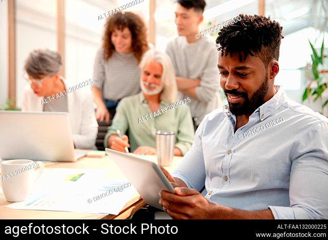 Businessman working with digital tablet during meeting