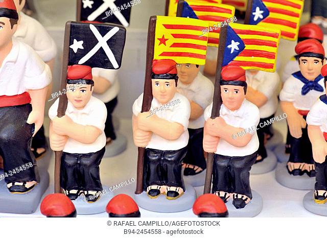 'Caganers', Catalonia independent flag, particular feature of modern nativity scenes at Santa Llucia Christmas fair, Barcelona. Catalonia, Spain