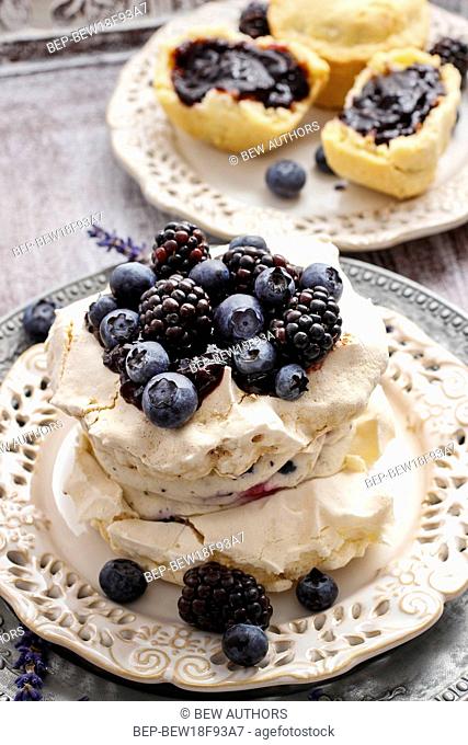 Pavlova cake with blueberries and blackberries. Summer party dessert