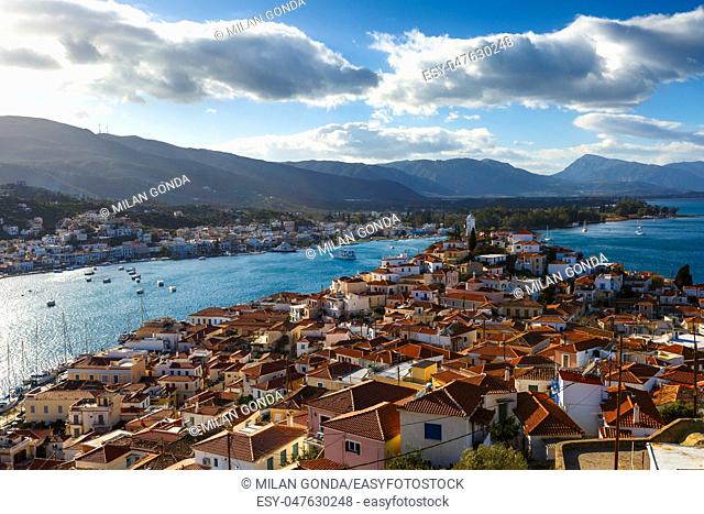 View of the Chora village of Poros island and Galatas village in Peloponnese from a nearby hill, Greece.