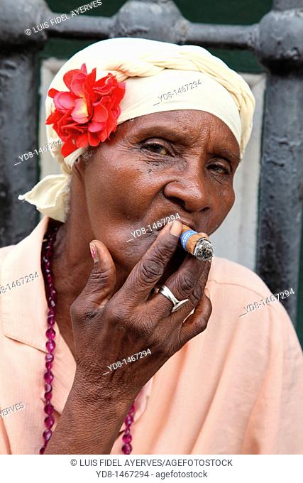 Morena woman smoking cigar black woman representative to the Cuban typical of the time in Old Havana, Cuba