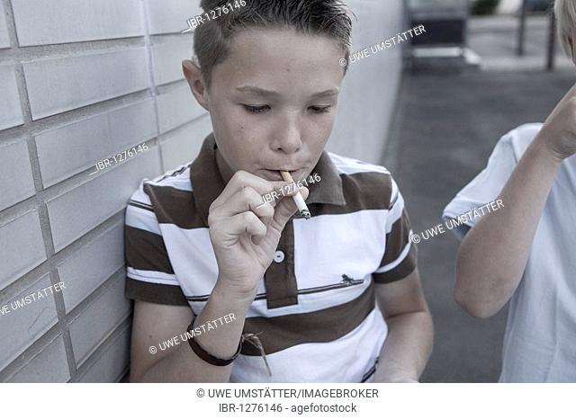 Young boy smoking a cigarette