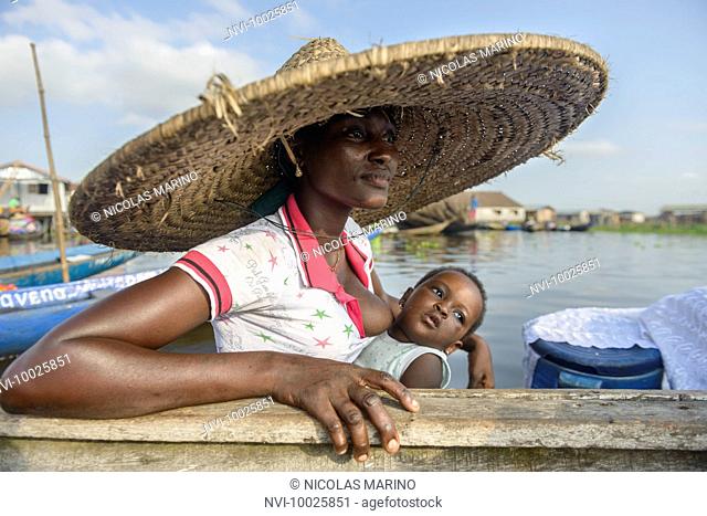 Woman with baby of the floating village of Ganvié, Benin, Africa