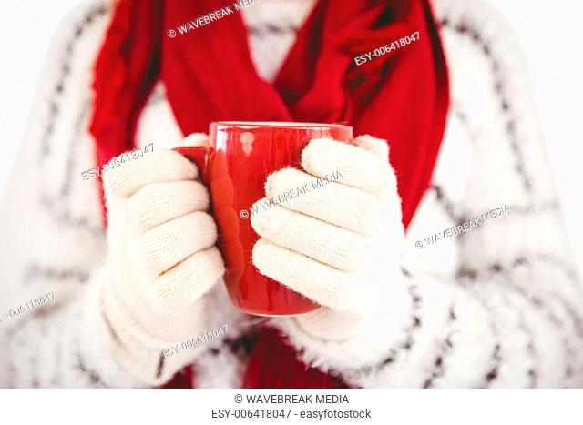 Woman in warm clothing holding mug