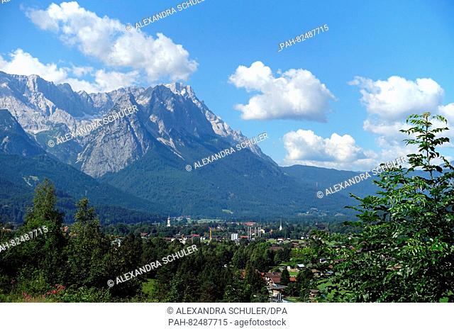 A view from Wank mountain of the Wetterstein mountains and Zugspitze peak (R) with the town in the valley near Garmisch-Partenkirchen,  Germany, 19 July 2016