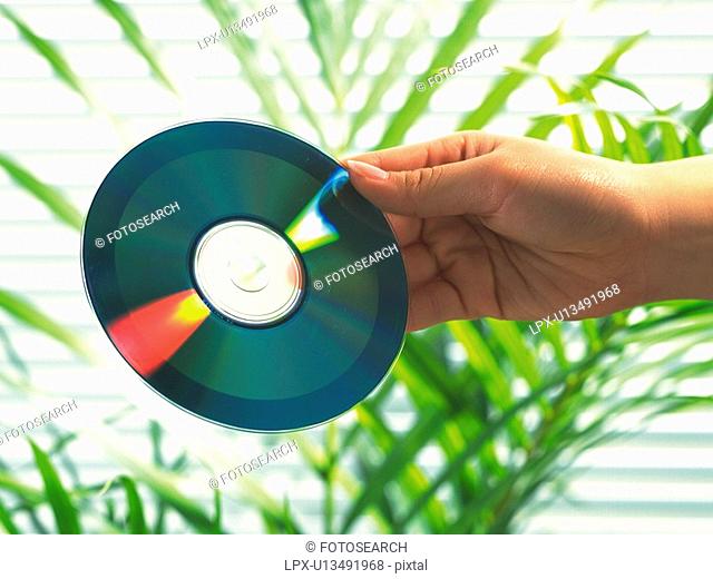 Hand holding a CD, Side View